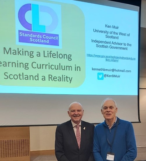 Alan Sherry, OBE standards next to Professor Ken Muir under a large screening displaying 'CLD Standards Council Scotland - Making a Lifelong Learning Curriculum in Scotland a Reality'