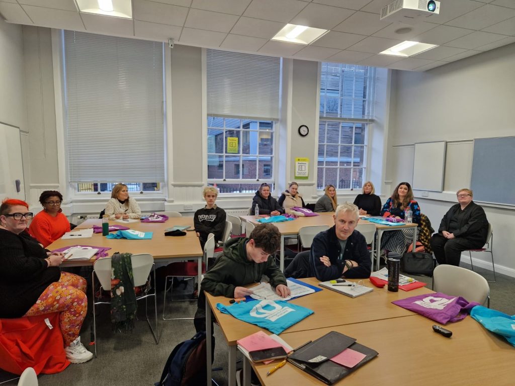 First year students from the Learning in Communities course at Edinburgh University sit round desks in a classroom