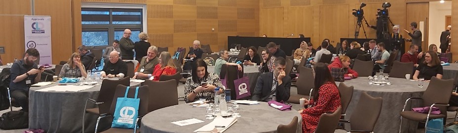 Delegates sit round large round tables at the CLD Standards Council Conference